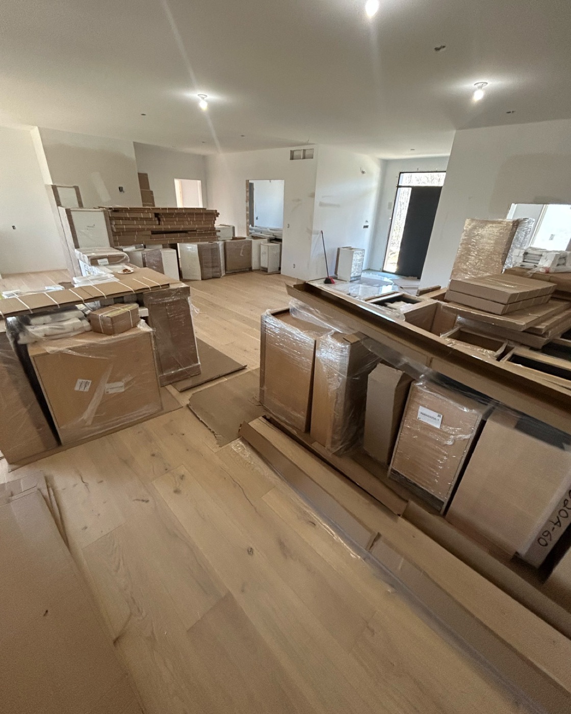 Hardwood flooring installation in progress with clean plank layout